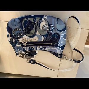 Blue, white, gray, and silver Coach purse